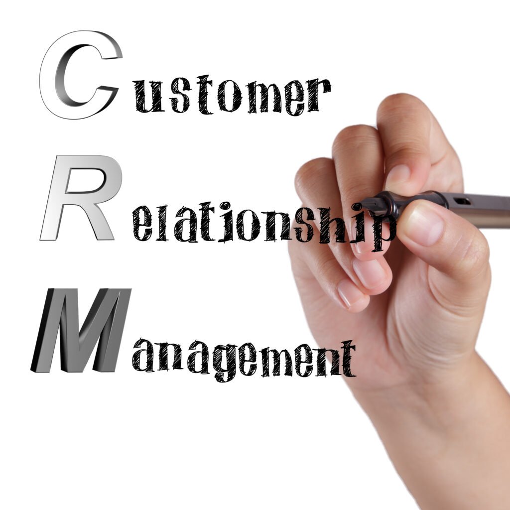 a Hand Holding a Pen Writes "customer Relationship Management" Vertically, with the Letters "crm" in Large Font on the Left Side, Illustrating a Key Focus Area in It Consulting.