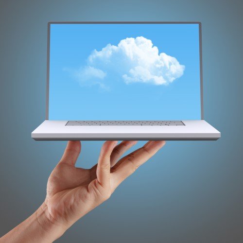 a Hand Holds a Laptop Displaying a Blue Sky with a White Cloud on Its Screen, Symbolizing the Seamless Integration of Cloud Computing.