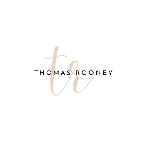 An elegant logo featuring the initials "tr" in light brown cursive, with "THOMAS ROONEY" in bold black capital letters overlaid.