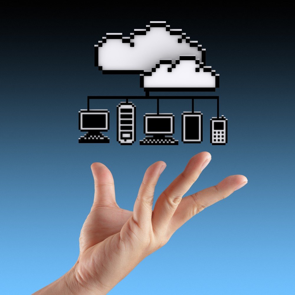 a Hand is Shown with an Illustration Above It Depicting a Hybrid Cloud and Various Connected Devices, Including a Desktop Computer, a Server, a Laptop, and a Smartphone Against a Blue Gradient Background.