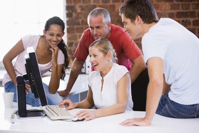 a Group of People, Focused on the Computer Screen, Experiencing an Excellent User Experience Interface That Aligns with Our Core Value.