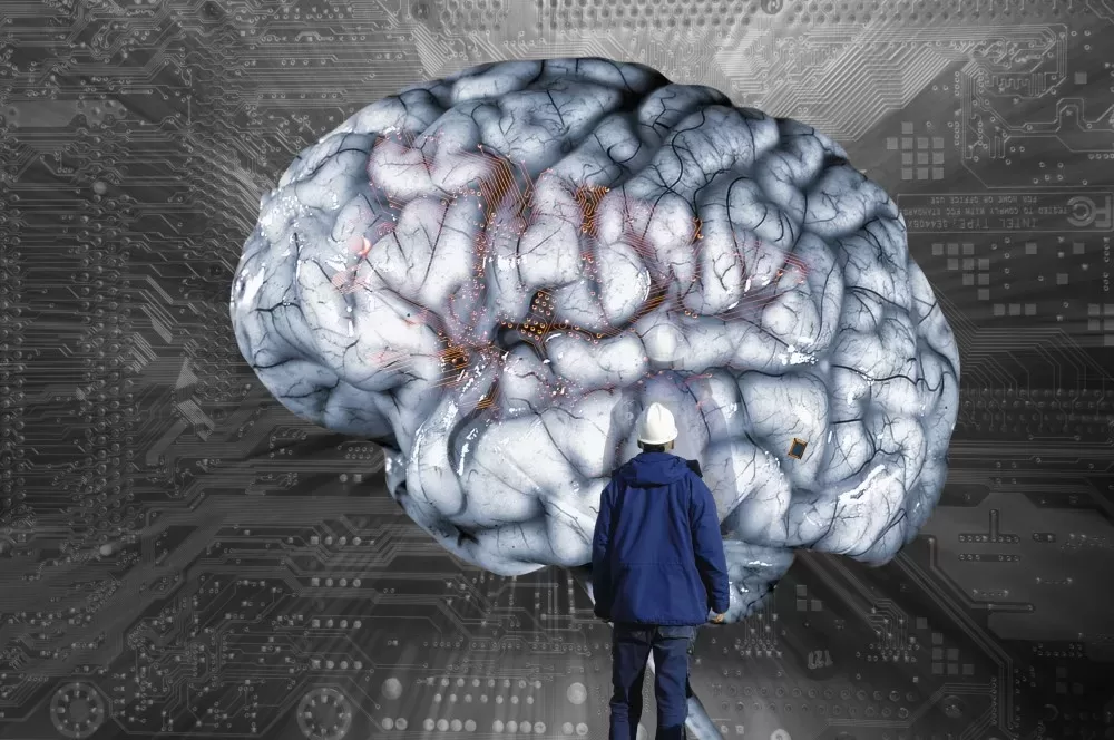 a Person in a Blue Jacket Standing in Front of a Large Digital Brain with Circuitry in the Background, Depicting a Concept of Ai and Neuroscience. Predictive Analytics