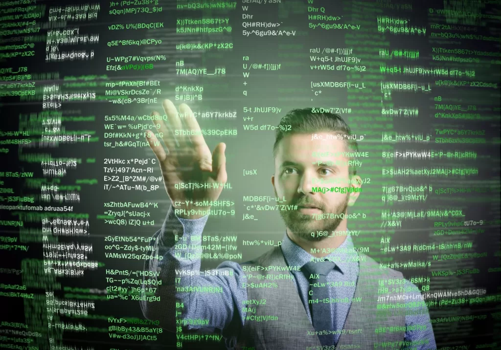 Man in a Suit Pointing at Digital Screens with Green Binary Code Overlay, Conveying a Concept of Cybersecurity or Digital Transformation.