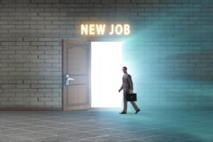a Person in a Business Suit Holding a Briefcase Takes Confident Steps Towards an Open Door with Bright Light and a "new Job" Sign Above It, Ready to Stand out in Their Newly Promoted Position.
