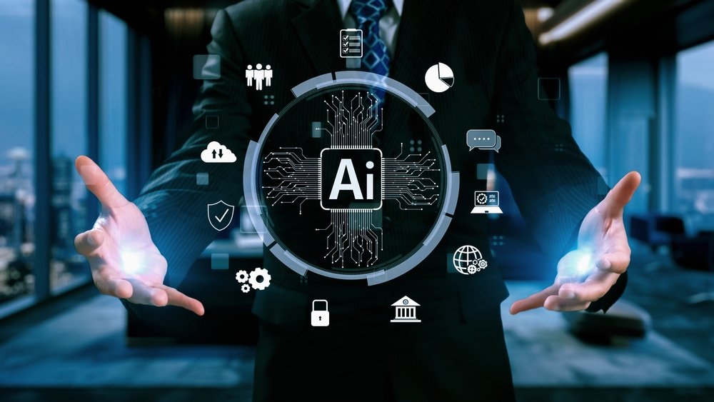 in a Sleek, Modern Office, an It Consultant in a Suit Unveils a Holographic Interface. at Its Center Glows "ai," Encircled by Icons Symbolizing Key Technologies and Concepts, Showcasing Ai As a Mandatory Tool in Today's Tech-driven Landscape.