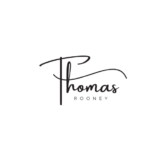 the Image Shows the Name "thomas Rooney" in Stylized Black Script on a White Background, with "thomas" in Cursive and "rooney" in Uppercase Below It.