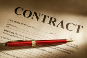 a Red Pen Rests on an Open Contract Document, Partially Filled out with an Imposing "contract" Heading. It's a Pivotal Moment in It Consulting, Where Every Detail and Add-in Counts Towards Success.