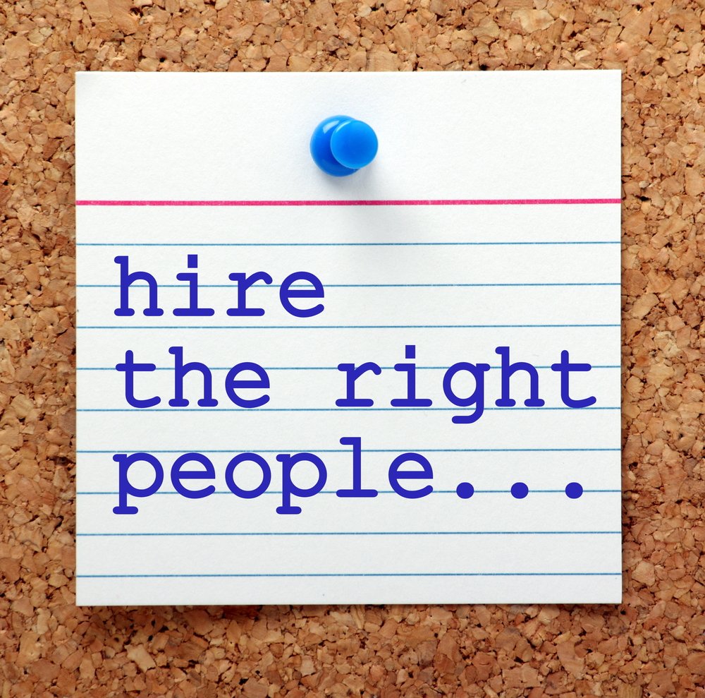 an Index Card Pinned to a Cork Board Displays the Text "hire the Right People..." in Blue Typewriter Font, Subtly Emphasizing Effective Hiring Practices Crucial for Success in the It Industry.